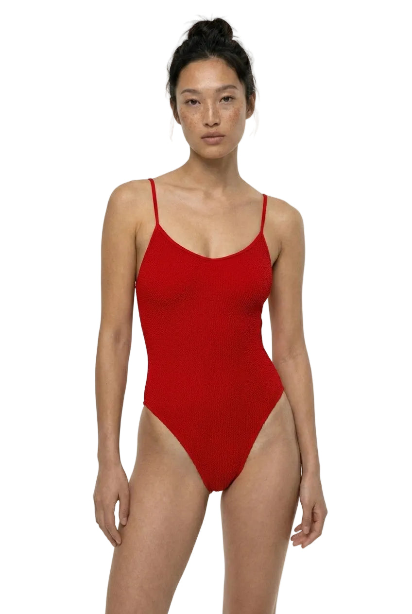 Woman wearing a red swimsuit on a white background