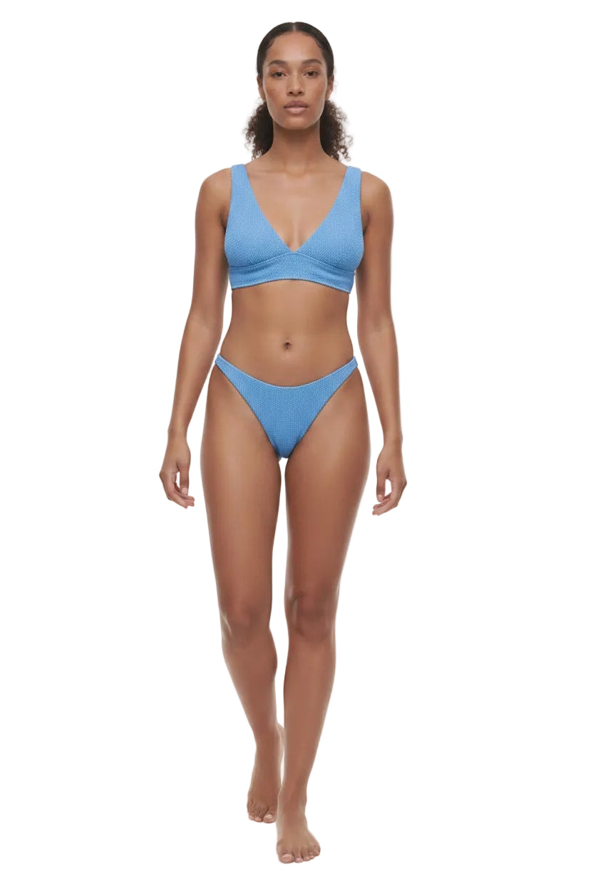Woman wearing a blue bikini on a white background