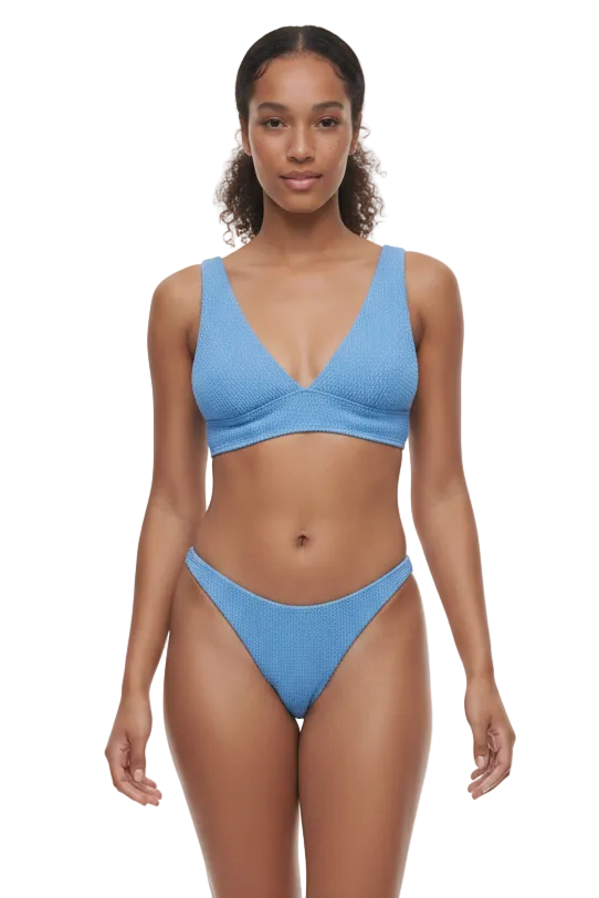 Woman wearing a blue bikini on a white background