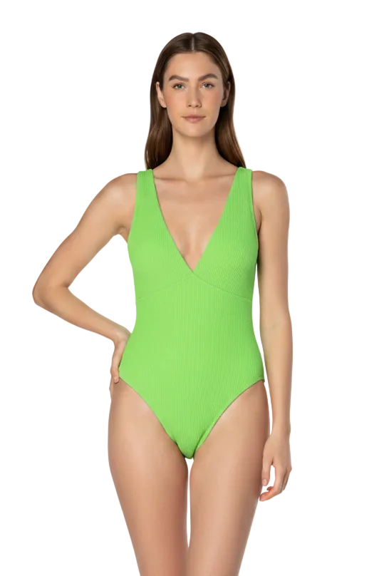 Woman wearing a bright green one-piece swimsuit on a white background