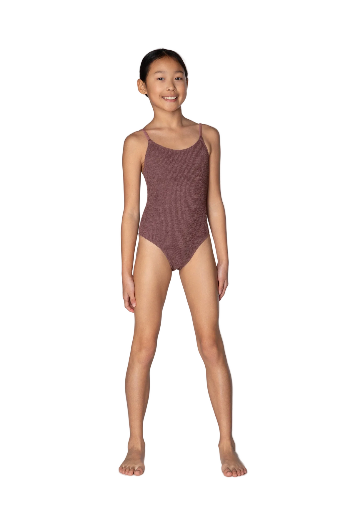Young girl wearing a brown swimsuit on a white background