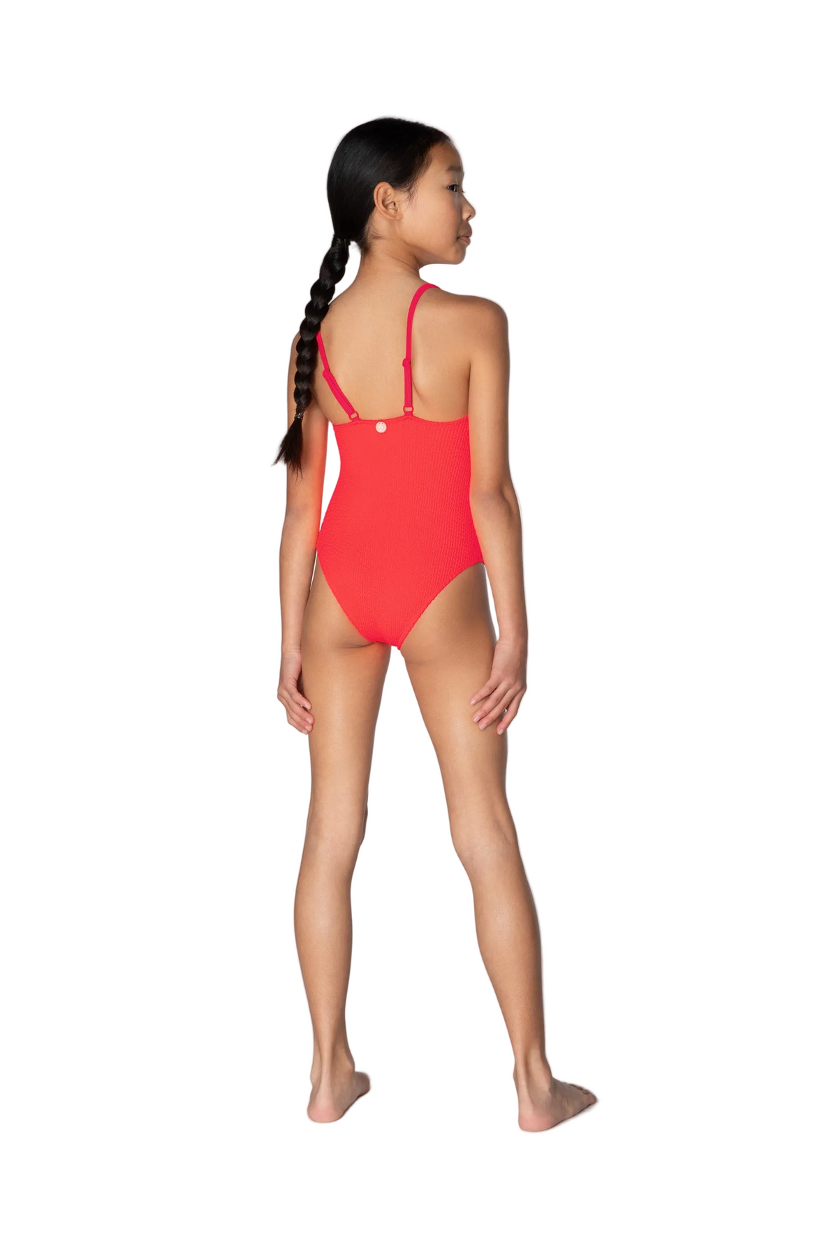 Girl wearing a red swimsuit on a white background