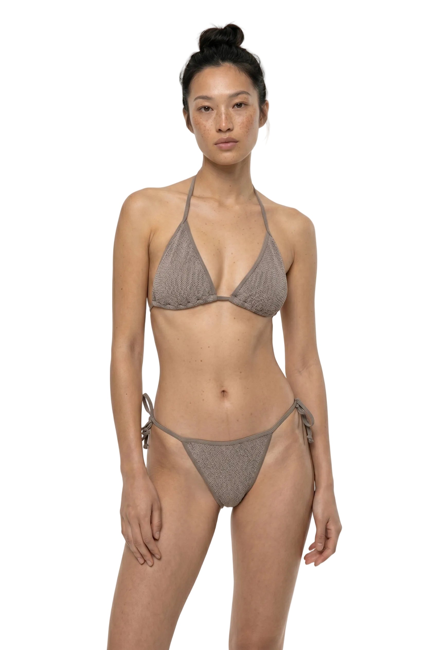 Woman wearing a gray bikini on a white background
