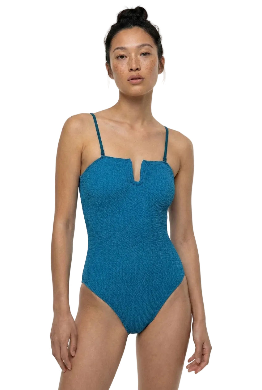 Woman wearing a blue swimsuit on a white background