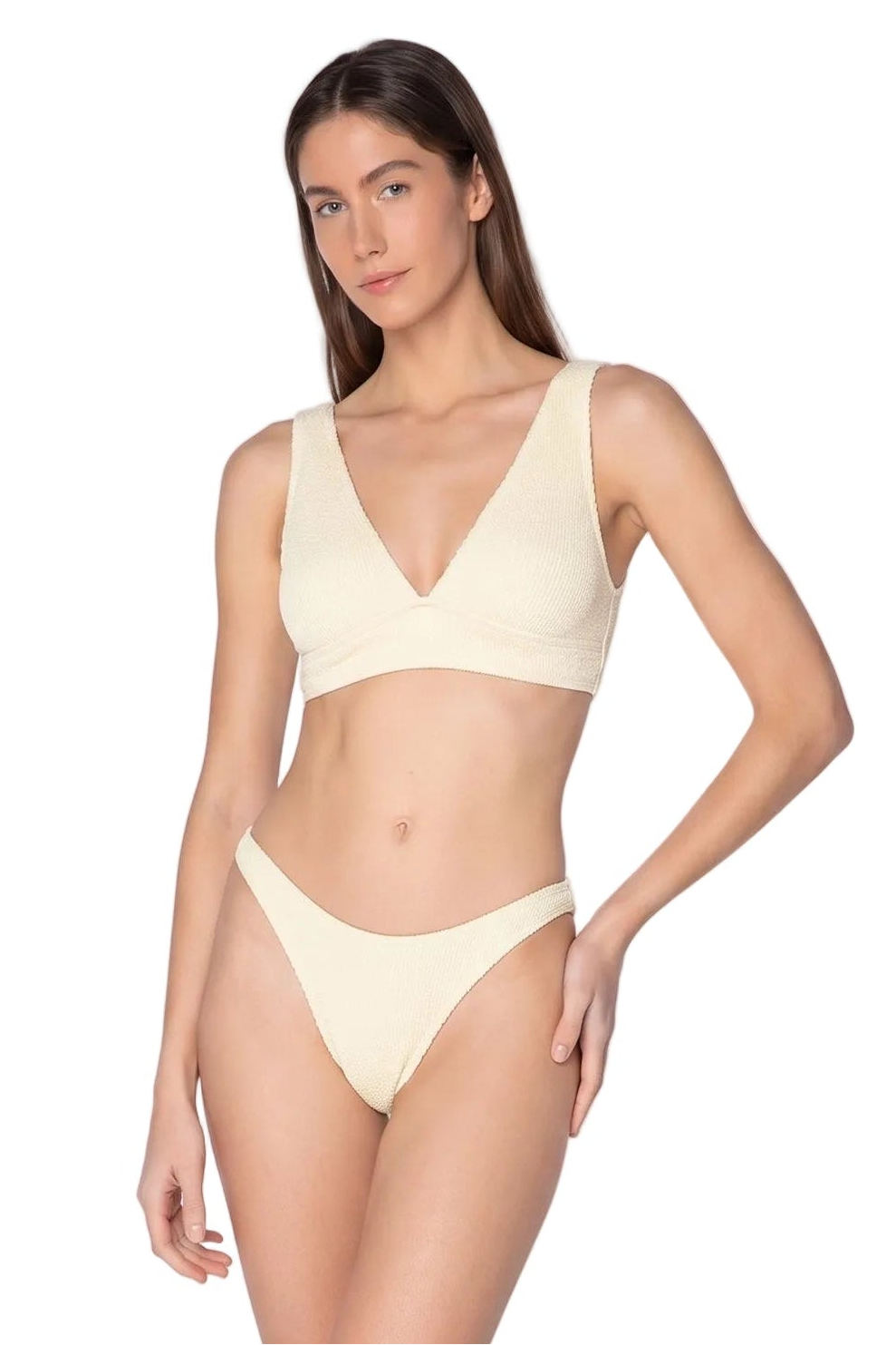 A woman modeling a ribbed two-piece bikini set in a light cream color against a solid white background.