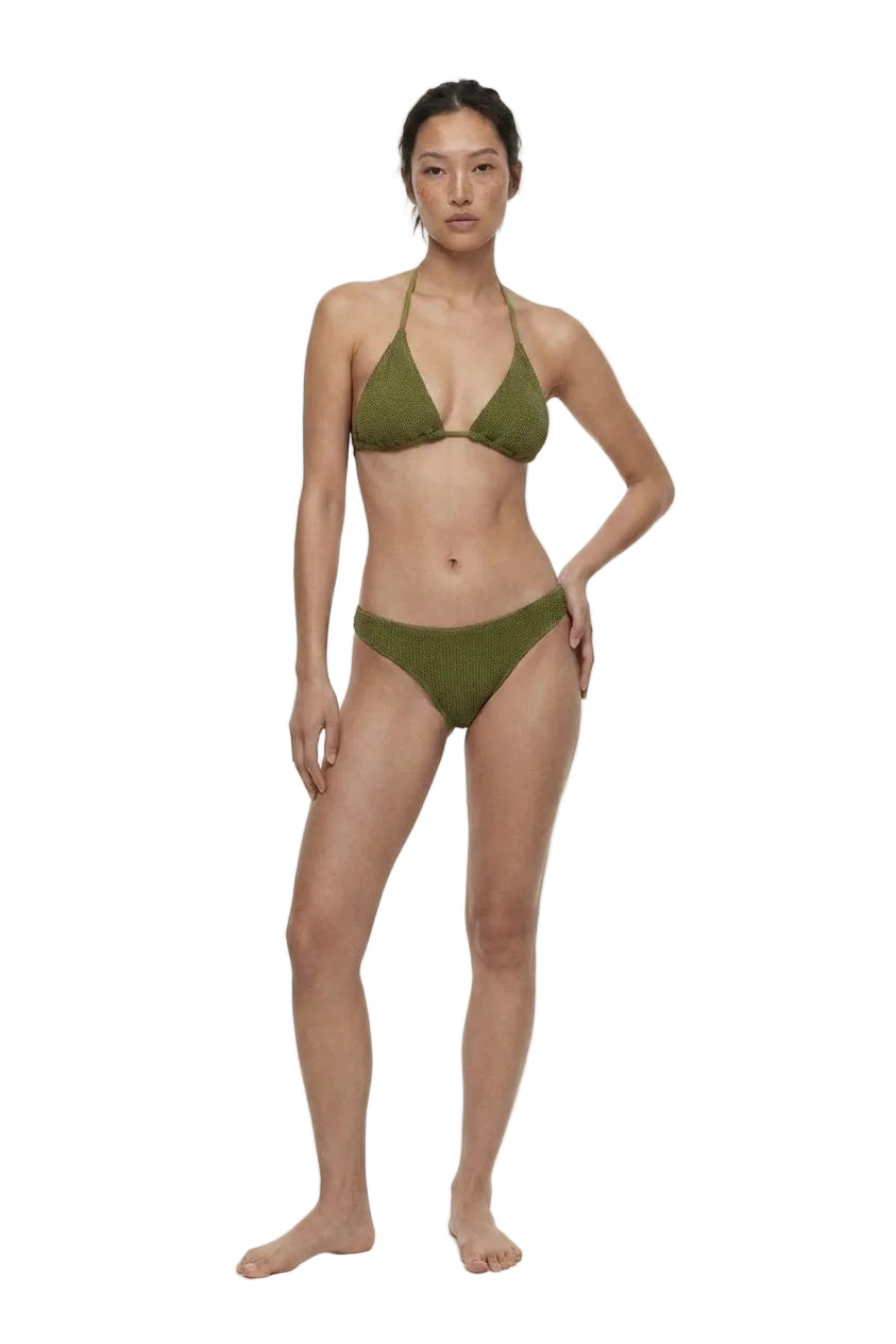 Woman wearing a green bikini on a white background