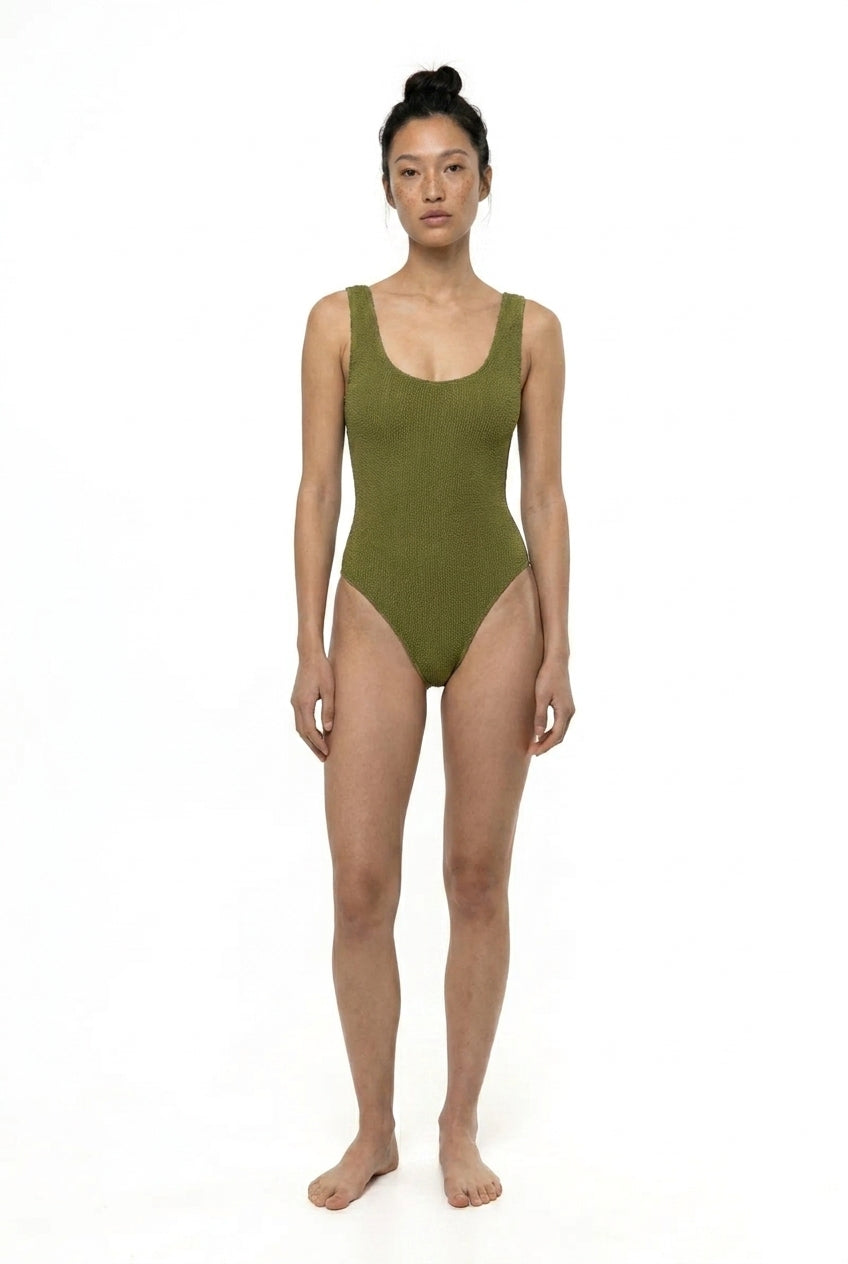 Person wearing a green swimsuit on a white background
